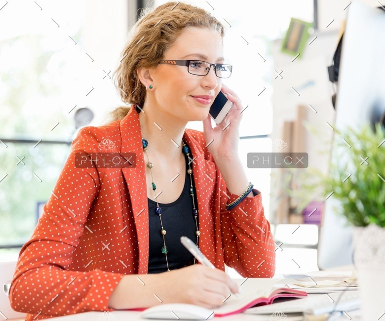 demo-attachment-138-young-woman-holding-mobile-phone-in-office-PE9ARDR